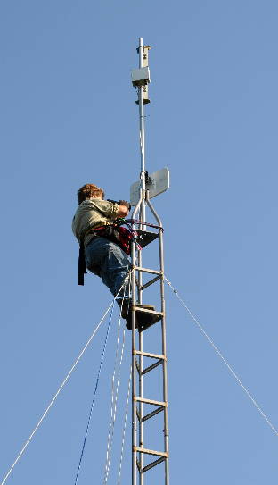 Cliff attaching an antenna to the tower