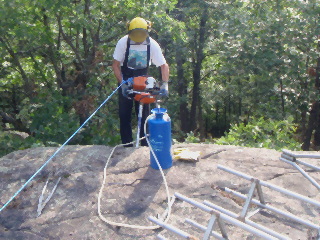 Eric drilling guy wire anchor